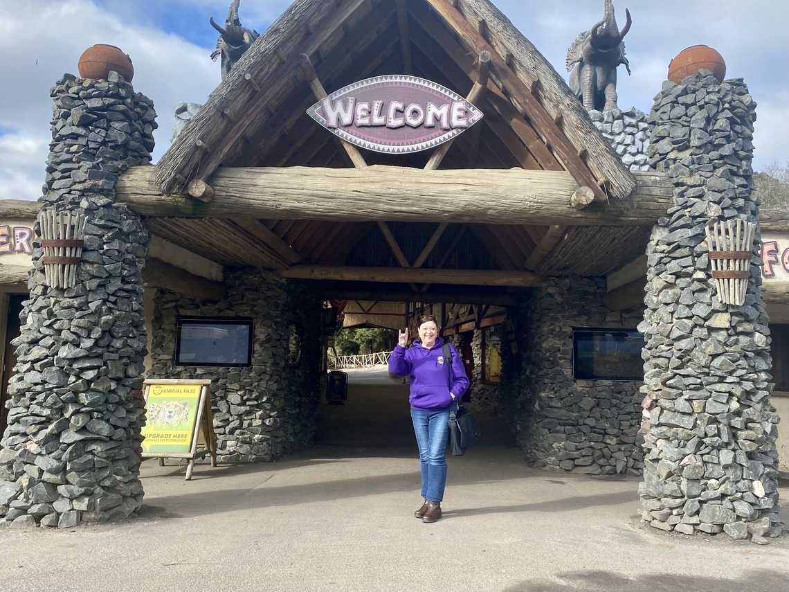 Woman in purple hoodie stands at entrance to West Midlands Safari Park