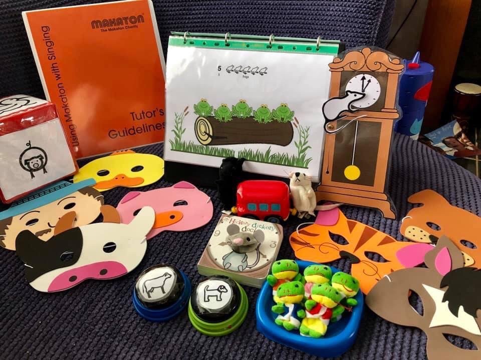 Makaton singing resources and props for early years songs, including Five Little Speckled Frogs, animal masks, toy animals and a toy bus.