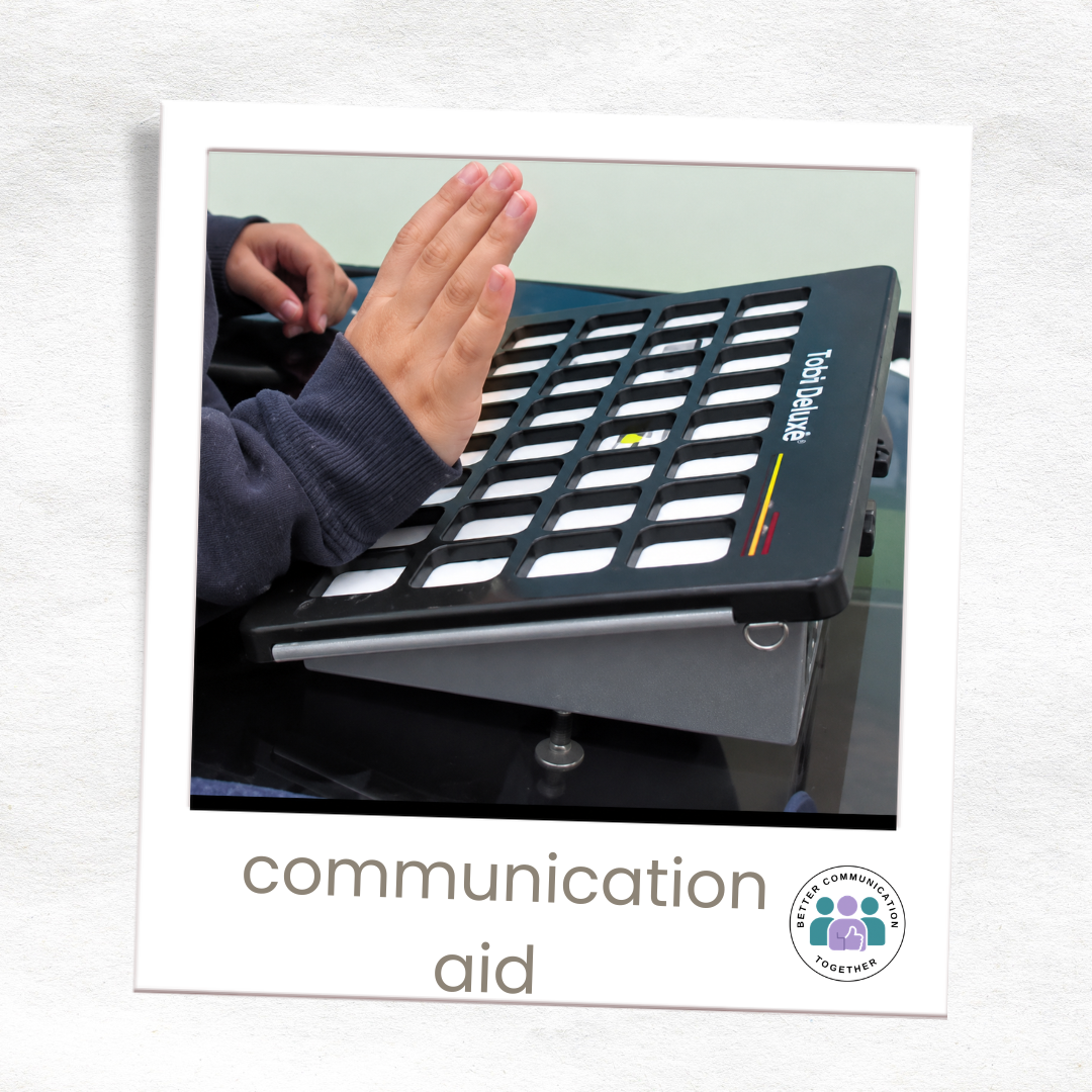 Person using their hand to access a grid-based voice output communication aid.